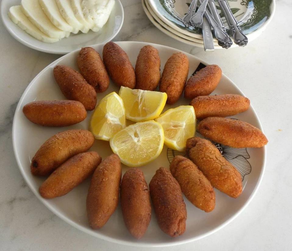 Traditional Cypriot Koupes bulgur k&ouml;ftesi - golden crispy torpedoes served with lemon