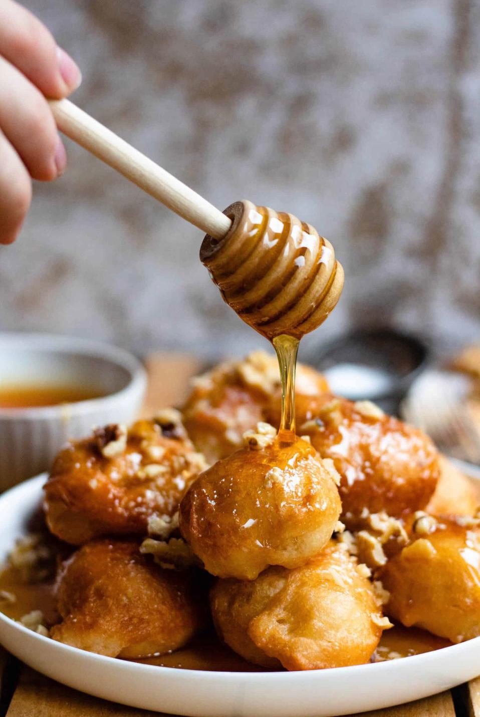 Traditional Cypriot loukoumades drizzled with honey and nuts at Lefkara Christmas Village near Protaras.