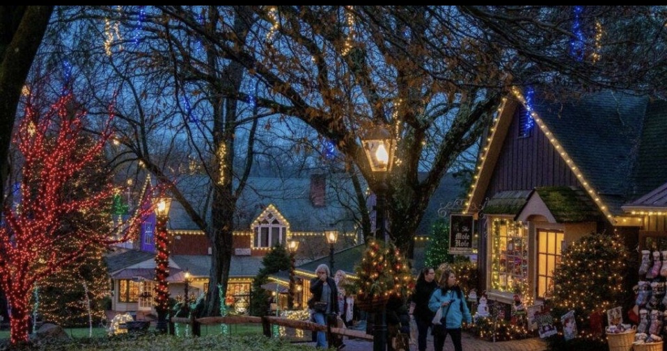 Traditional Cypriot street in Lefkara with Christmas ornaments, golden lights, and visiting tourists.